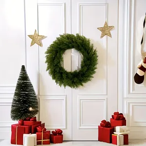 Lush green artificial pine wreath hanging on a white door for Christmas decoration