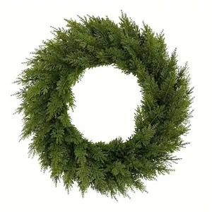 Close-up of artificial green pine needle wreath for festive Christmas home decor