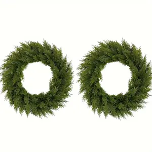Pair of realistic artificial pine and cypress green wreaths for festive holiday decor.