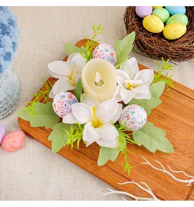 Detail of Easter egg candle holder wreath with white lilies and patterned eggs