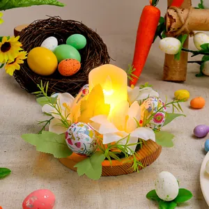 Decorative Easter egg candle holder with floral wreath and LED candle for festive table decor.