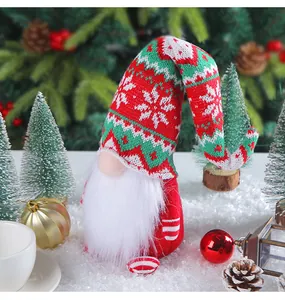 Detailed view of a Christmas gnome doll with a red and green knitted snowflake hat.