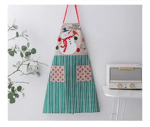 Detailed macro view of linen Christmas apron featuring snowman print and green stripes