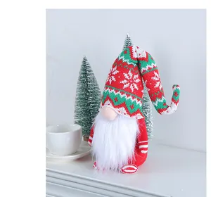 Close-up view of a handmade knitted long hat gnome doll with a festive white beard