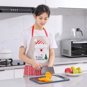 Festive Santa Claus linen apron worn by a model in a clean modern kitchen setting.