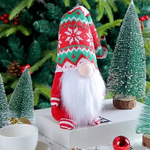 Festive knitted Christmas gnome doll with long snowflake hat and plush white beard.