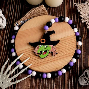 Guirlande de perles d'Halloween avec sorcière et pompon en jute pour décoration festive