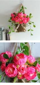 Close-up detail of artificial pink roses in a rustic woven hanging basket for home decor.