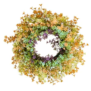Vibrant spring artificial wildflower wreath with colorful plastic daisy blossoms for home decor.