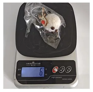 Detailed weight measurement showing small white reindeer fur ball ornament at 6 grams