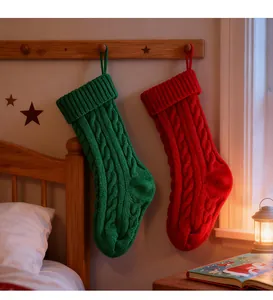 Detail of cozy red and green cable knit Christmas stockings hanging in a warm festive bedroom.