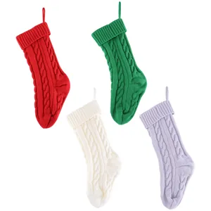 Set of four cable knit Christmas stockings in red, green, white and lavender colors