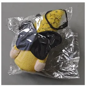 Detailed view of bee festival gnome plush pendant inside clear plastic packaging