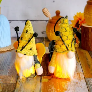 Pair of light-up bee gnomes with yellow hats and wings for Bee Day festival home decor