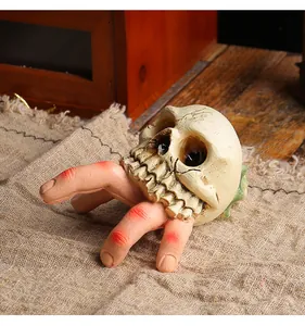 Halloween resin horror ornament featuring a realistic skull and severed fingers design.