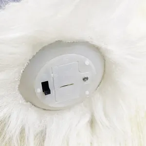 Detail of battery compartment and ON/OFF switch on white furry Christmas decor