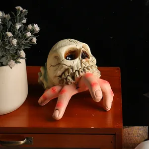 Spooky Halloween resin skull with zombie hand ornament for indoor and outdoor decor