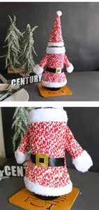 Detailed close-up of knitted Santa Claus wine bottle cover set with faux fur trim