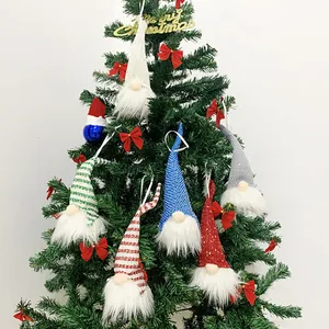 Handmade plush Christmas gnome ornaments set hanging on a green tree decoration