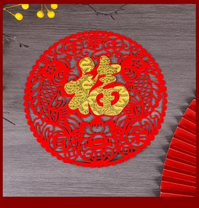 Close-up detail of traditional red non-woven Fu sticker with hollow koi patterns