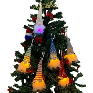 Nordic Christmas gnome hanging ornaments with LED lights on a holiday tree