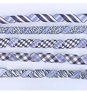 Close-up of assorted black and white ribbons with leopard, zebra, and checkerboard patterns