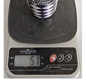 Detail shot showing the weight of a black and white checkered ribbon roll at 51g