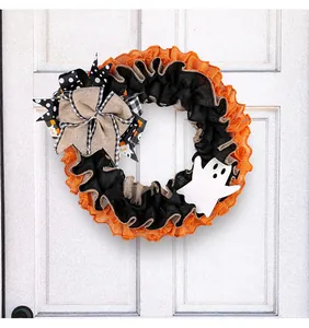 Decorative Halloween burlap wreath featuring a white ghost and a large rustic bow