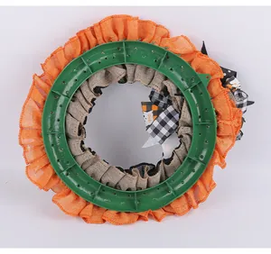 Detailed back view of Halloween burlap ghost wreath showing the sturdy green plastic frame