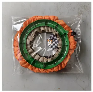 Detailed back view of Halloween orange burlap wreath in transparent plastic packaging.