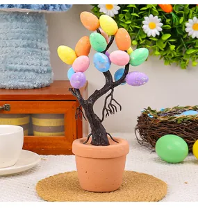 Close-up of Easter egg tree bonsai with colorful speckled eggs in a terracotta pot