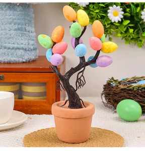 Decorative Easter egg tree in a small pot with colorful speckled eggs for festive decor.