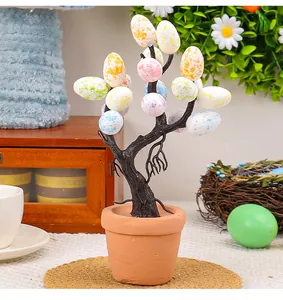 Detailed close-up view of a creative Easter egg tree in a pot with speckled patterned eggs