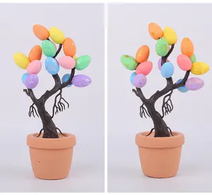 Close-up of Easter egg tree ornament with colorful spotted eggs in terracotta pot