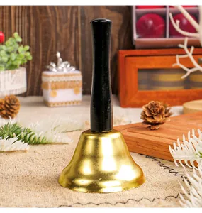 Classic gold metal Christmas handbell with black wooden handle for festive holiday decor.