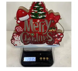 Digital scale weighing a glowing wooden Merry Christmas door sign showing 283.5 grams.