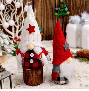 Close-up of festive Christmas gnomes featuring knitted hats and cozy plaid outfits