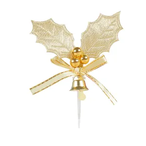 Elegant gold Christmas cake topper featuring holly leaves bow and bell for party decor