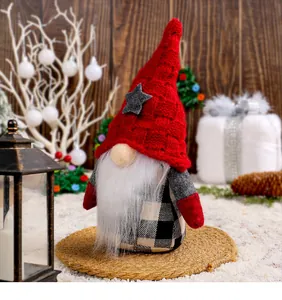 Close-up of a festive Christmas gnome featuring a red knitted hat with a grey star.