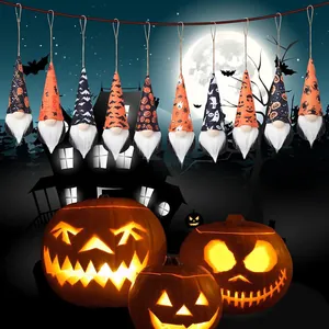 Detailed view of Halloween gnome hanging ornaments with Jack-o'-lantern background