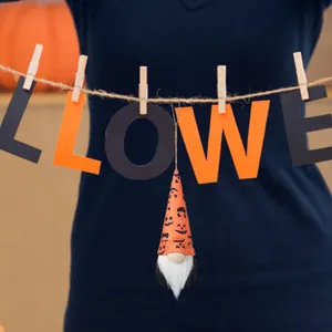 Close-up of a Halloween gnome ornament with a pumpkin print hat and a long white beard