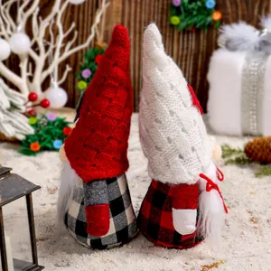 Pair of festive Christmas gnomes with knitted hats and plaid outfits in a snowy scene.