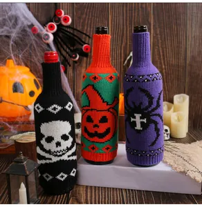 Detail of Halloween knitted wine bottle covers with skull pumpkin and spider designs
