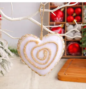 Detail shot of white felt heart Christmas ornament with natural jute rope spiral pattern.