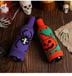 Halloween knitted wine bottle covers with spider and pumpkin patterns in a festive setting