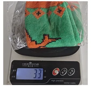 Detailed photo showing the 33g weight of a Halloween knitted wine bottle cover