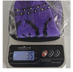 Detailed shot showing the 35g weight of a purple knitted Halloween wine bottle cover