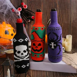 Set of three Halloween knitted wine bottle covers with skull, pumpkin, and spider patterns.