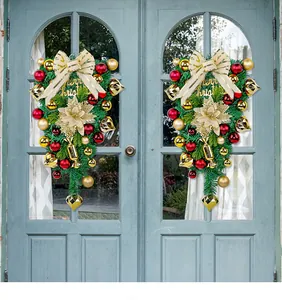 Detailed view of two festive Christmas swags with red and gold ornaments on a blue door