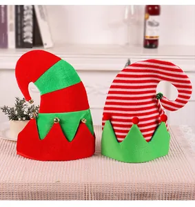 Close-up detail of striped Christmas elf hats with small bells on a festive table